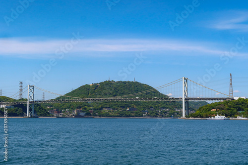 Kanmon Bridge and Mount Hinoyama seen over the sea from a ferry on Kanmon Strait, Japan, May 12, 2026