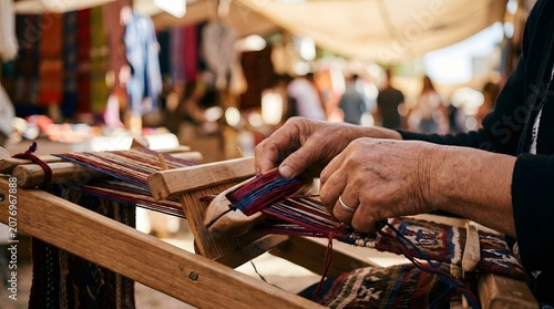 Artisan hands weaving colorful threads on a wooden loom craft