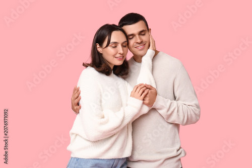 Cheerful young couple huggi...