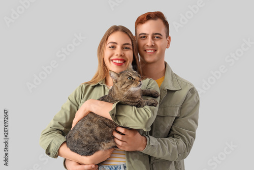 Young couple with cute cat ...