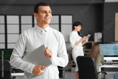 Male programmer with laptop...