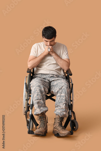 Sad young soldier in wheelc...
