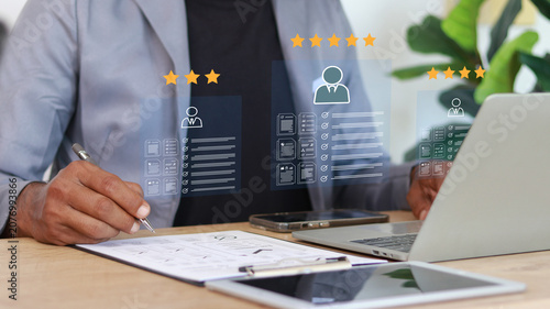 Tableau sur toile Business professional evaluating candidate profiles and performance ratings through a digital HR interface
