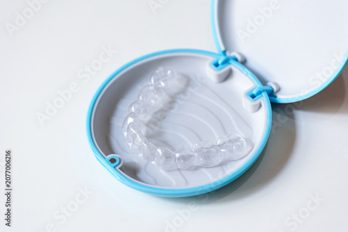  clear aligners device in the mouth on a white background. (invisalign)