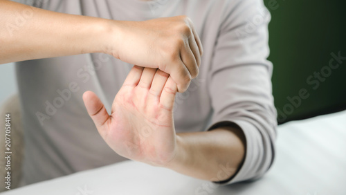 Close-up of a person stretching the wrist and hand to relieve stiffness, improve flexibility, and prevent repetitive strain injury, supporting physical therapy, rehabilitation, fitness, and wellness.
