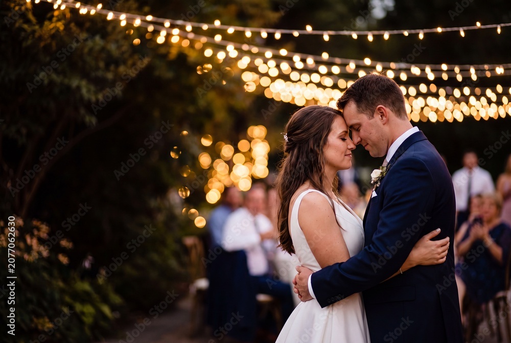 Fototapeta premium Romantic Wedding Couple Dancing Under String Lights
