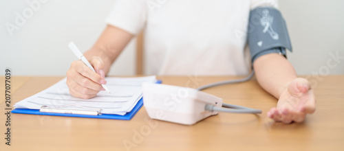 Photos woman checking Blood pressure by Blood pressure monitor with Cuff