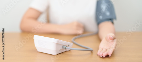 Obraz na plátně woman checking Blood pressure by Blood pressure monitor with Cuff