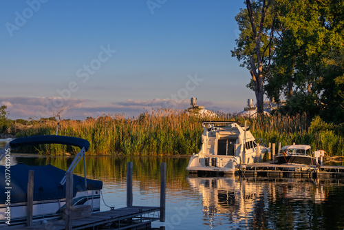 Canvas-taulu Boats moored at marina dock during golden hour sunset