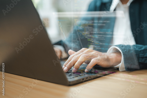 Фотография Programmer coding software on a laptop with source code displayed on screen, representing software development, web application engineering, artificial intelligence