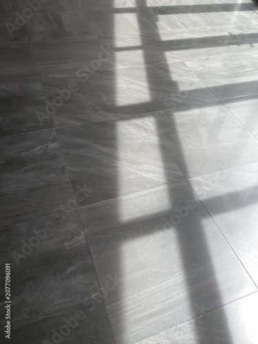 Strong Window Frame Shadow on Grey Tiled Floor