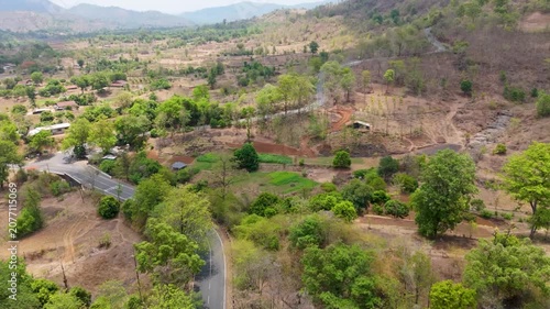 Beautiful aerial view of Wilson Hills located in Gujarat- India, A high-resolution aerial drone photograph of a winding mountain road featuring multiple hairpin bends through a dry deciduous forest