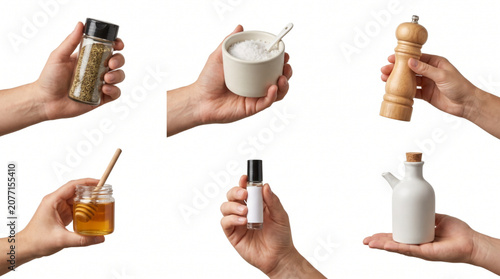 Tableau sur toile Collection of diverse human hands holding various kitchen ingredients like salt, pepper mill, honey jar, dried herbs, oil cruet and small extract bottle, isolated on a clean white background