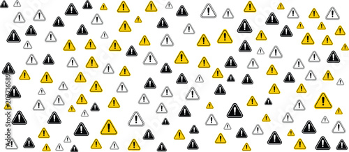 A collection of various warning signs arranged in a pattern on a plain surface with multiple triangular symbols.