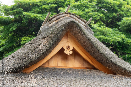 Traditional thatched roof gable with wooden vent panel