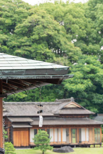 Japanese wind chime hanging from copper roof eave with tradition