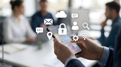Businessman using smartphone with digital icons for security and communication