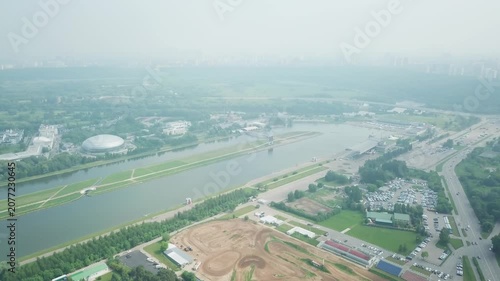 Drone circling over motocross track and pond