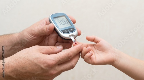 Person checking blood sugar levels with glucometer device
