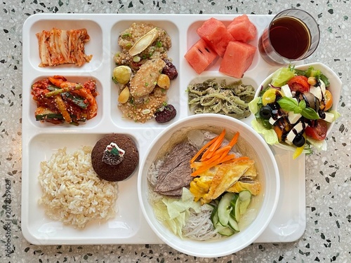 A vibrant spread of Korean food on the table, featuring various banchan (side dishes) like kimchi, pickled vegetables, and seasoned greens. Perfect for food photography, showcasing traditional Korean.