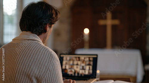 Pastor logging into a video platform to join a global online prayer community, the screen showing dozens of participants from multiple continents, a modest home altar with a