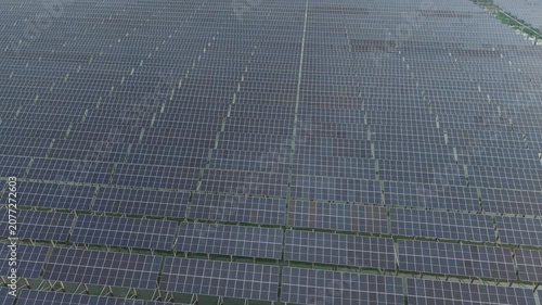 Solar Panel Field Aerial View with Grid Pattern, Showing Repeating Reflective Modules Across a Wide Energy Landscape