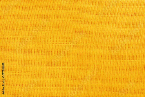 Yellow golden linen fabric cloth texture for background, natural textile pattern.