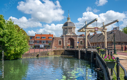 Historic morspoort gate and drawbridge over canal on a sunny summer day in Leiden Netherlands