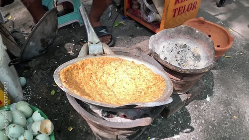 Kerak telor is a dish from the Betawi (Jakarta, Indonesia), consisting of an omelet mixed with white glutinous rice, dried shrimp, and spices.
