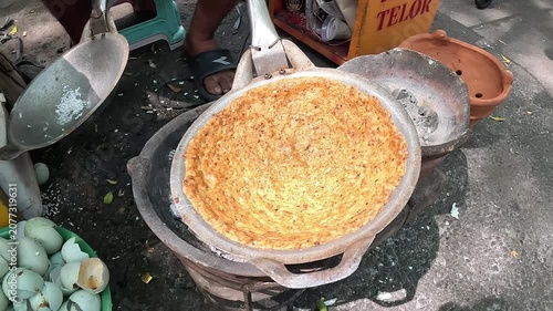 Kerak telor is a dish from the Betawi (Jakarta, Indonesia), consisting of an omelet mixed with white glutinous rice, dried shrimp, and spices.