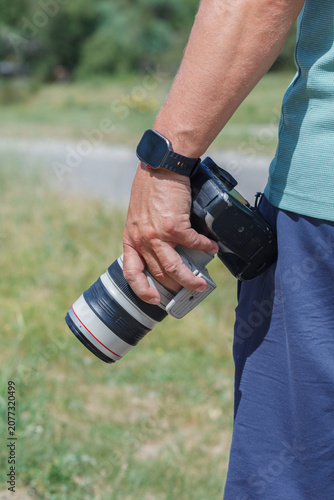 Hand holds camera, ready to capture moment