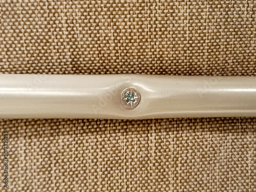 Fastening parts to furniture. Close-up of a screw being tightened.