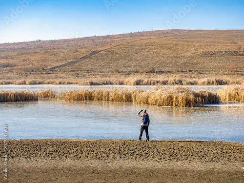 Lone Person Standing by Winter Lake Campenesti Wetland Landscape