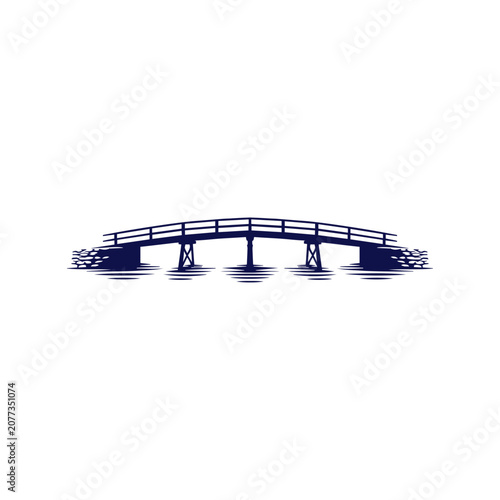 Silhouette of Arched Bridge Over Water with Reflections