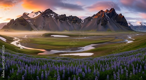 Golden hour over rolling green hills and mountain peaks.