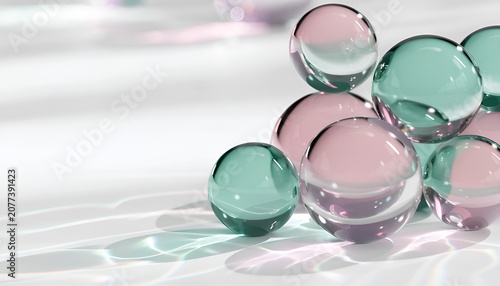 Abstract 3d render of teal and pink glass spheres on white surface with light reflections