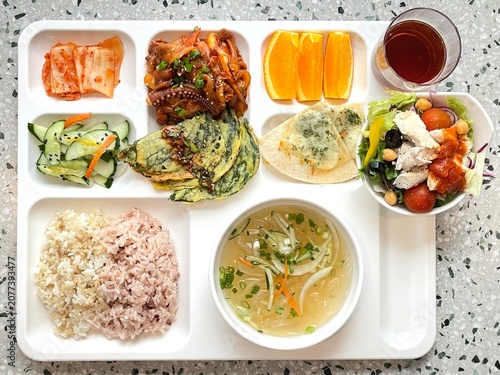 A vibrant spread of Korean food on the table, featuring various banchan (side dishes) like kimchi, pickled vegetables, and seasoned greens. Perfect for food photography, showcasing traditional Korean.