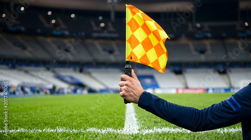 Close Up of Assistant Referee Signaling Offside on Football Sideline