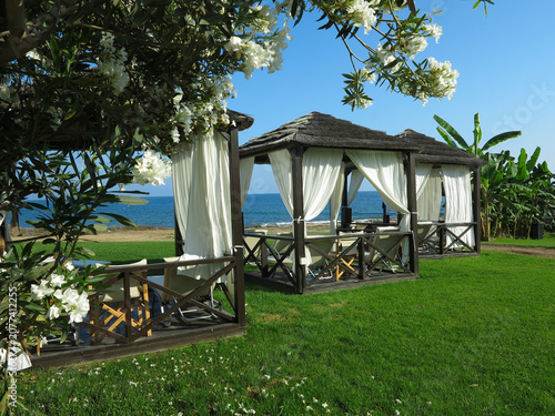 Beautiful landskape, palm trees and sun loungers at luxury resort