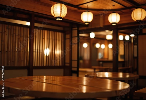 Wooden tables in a traditional Japanese izakaya with warm lantern lighting