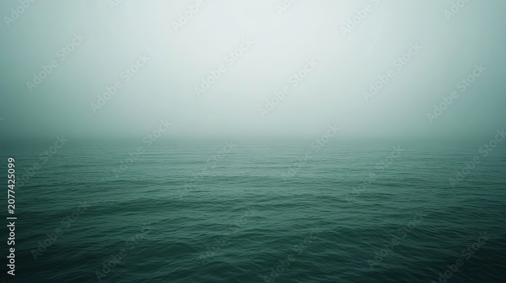 Fototapeta premium Calm sea under misty sky tranquil water hazy atmosphere