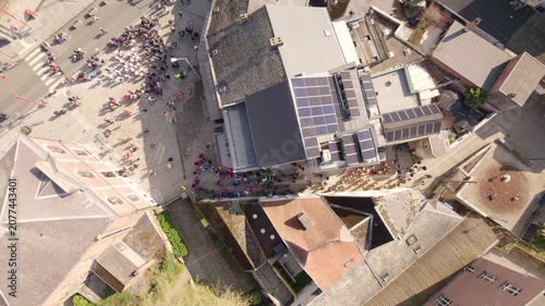 Top view of people celebrating Carnival in the streets, aerial drone footage