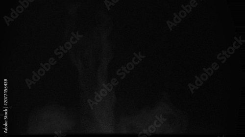 Heavy Hitting the Ground. A column of soil and dust rises into the air from the explosion. Isolated on black. Use in blend modes to simulate a battlefield