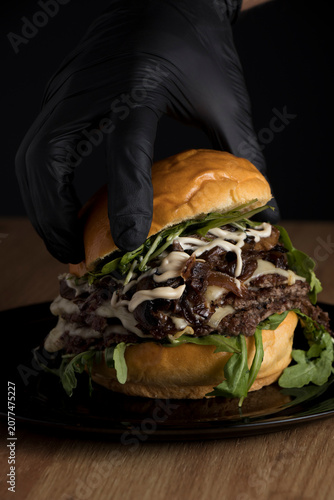 Quadro su tela A delicious triple smash burger with cheese, mayonnaise, caramelized onions, and bacon