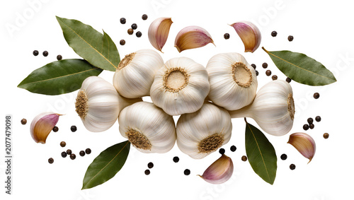 Garlic bulbs cloves bay leaves, and peppercorns arrangement