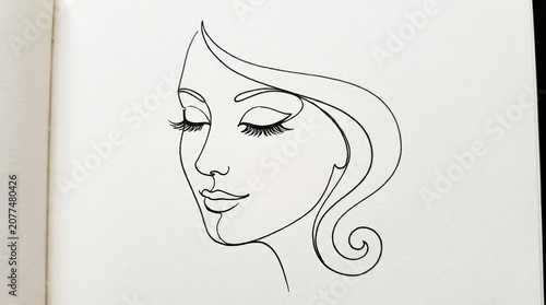 Minimalist line art drawing of a womans face in profile with long eyelashes
