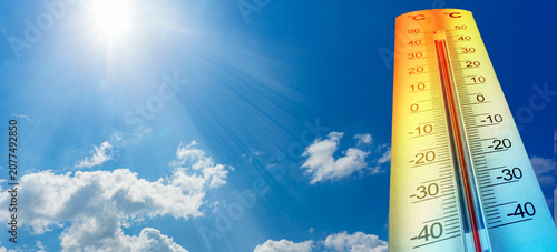 Thermometer showing high temperature under hot sunny sky