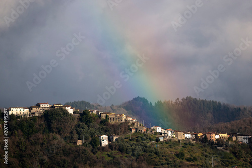 Rainbow over the medieval hill top town of Lugliano, Italy