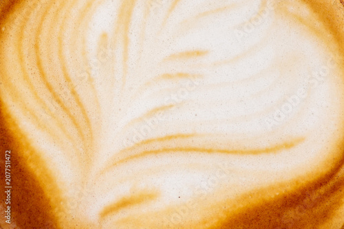 Obraz na płótnie A coffee background made of close up latte art foam shows delicate feathered pat