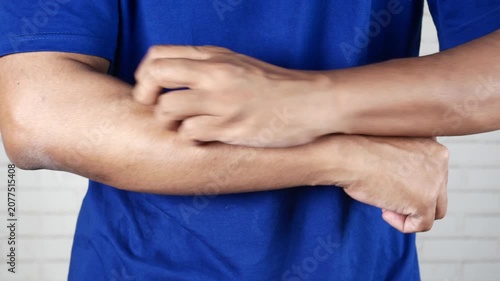 Close-up of a person scratching an itchy arm affected by skin irritation or allergic reaction. Dermatology, eczema, allergy symptoms, skin sensitivity, healthcare, and medical condition concept.